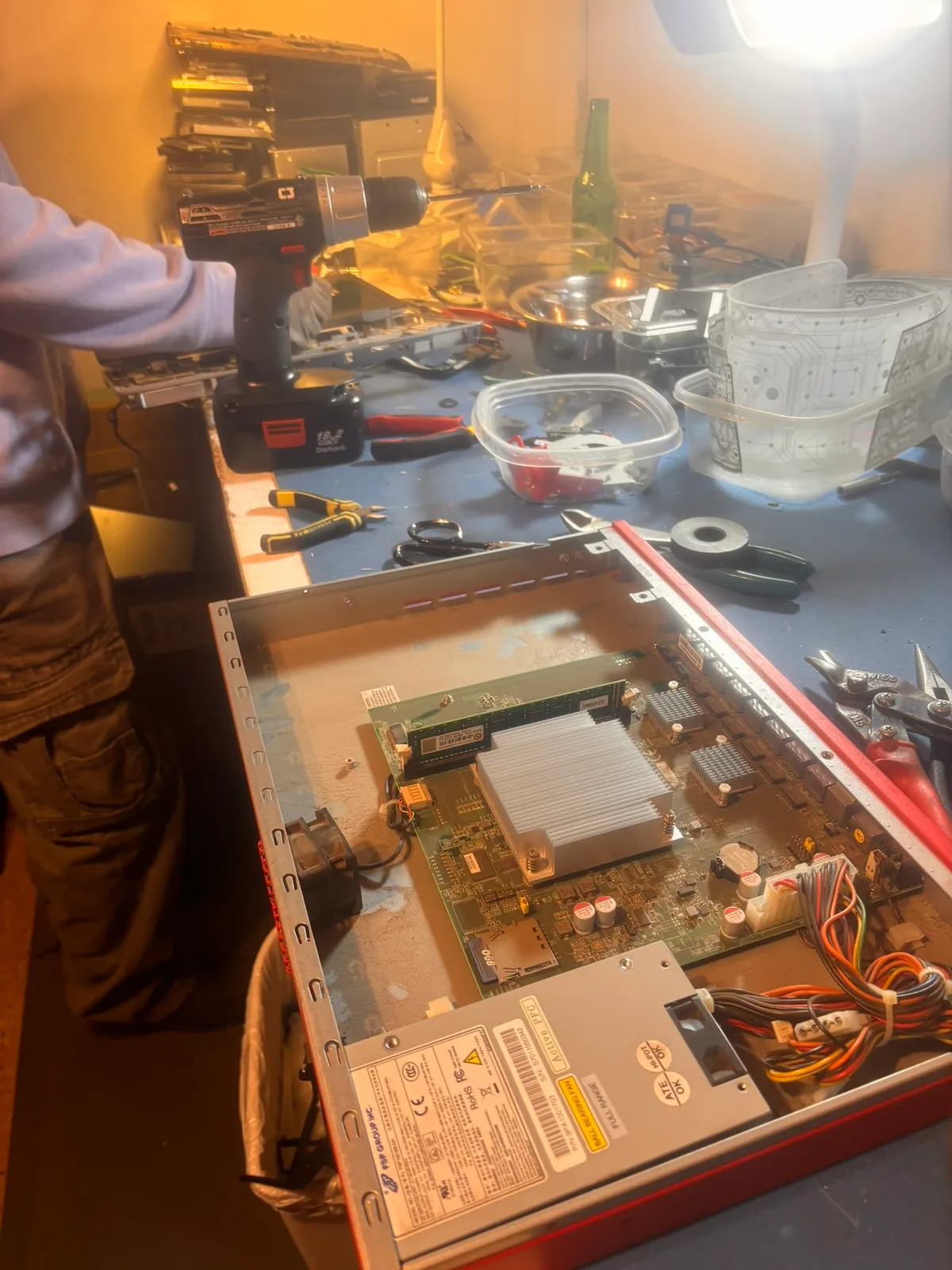 A rack-mount network switch opened up, exposing its motherboard, heatsinks, and memory