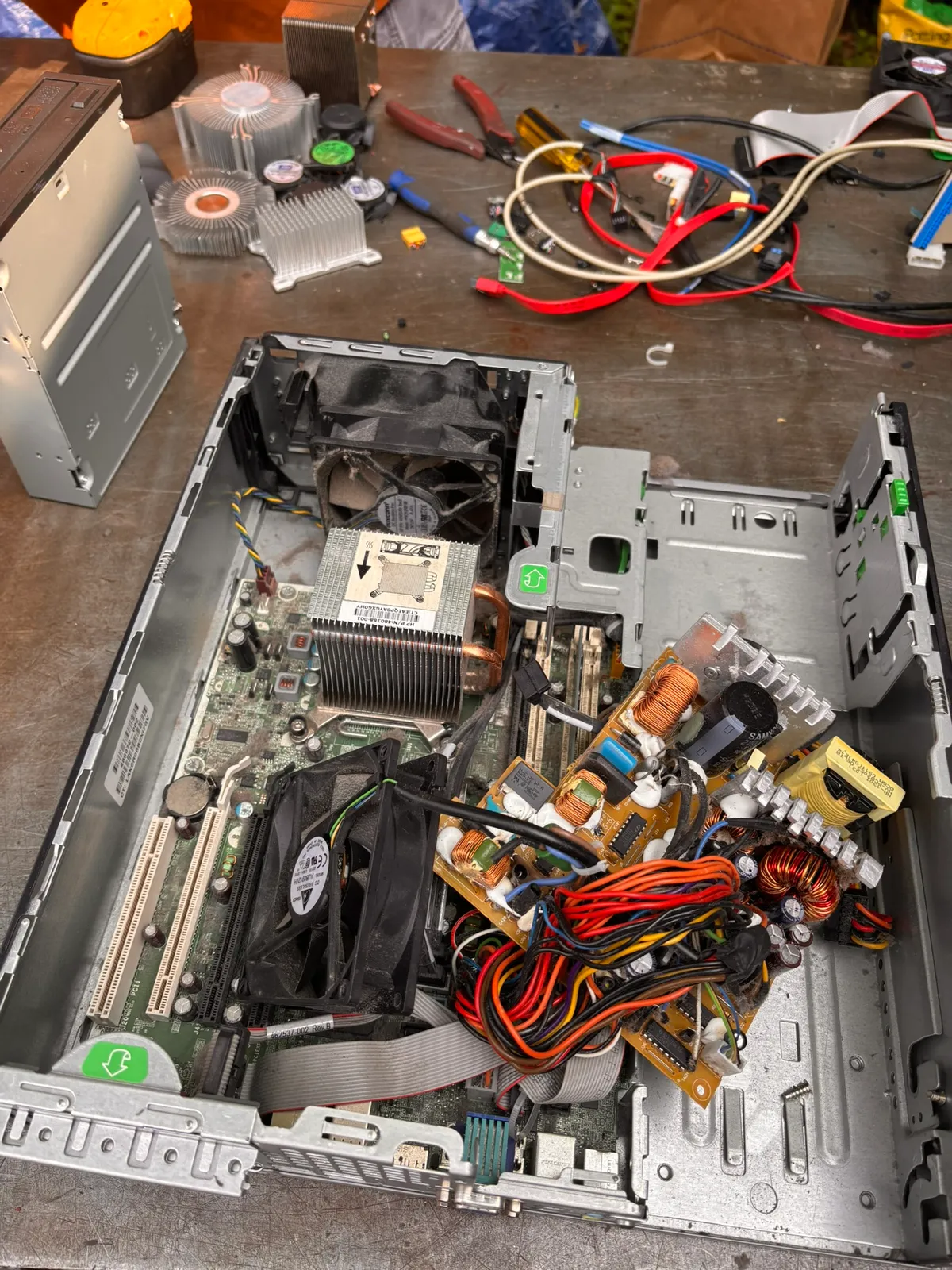 A desktop computer tower opened up, showing the motherboard, fans, and power supply wiring