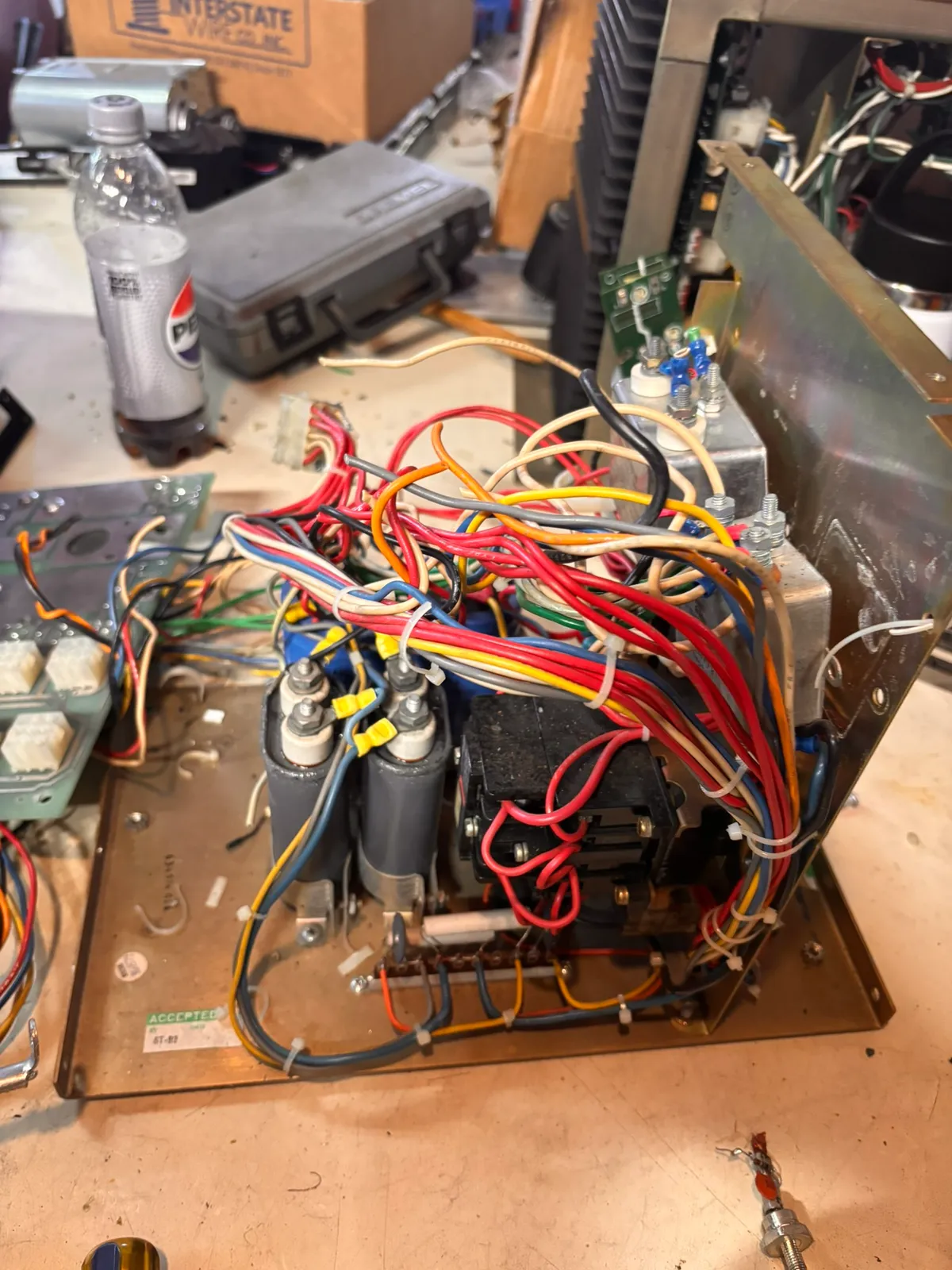 A tangle of wires, capacitors, and relays salvaged from a piece of equipment